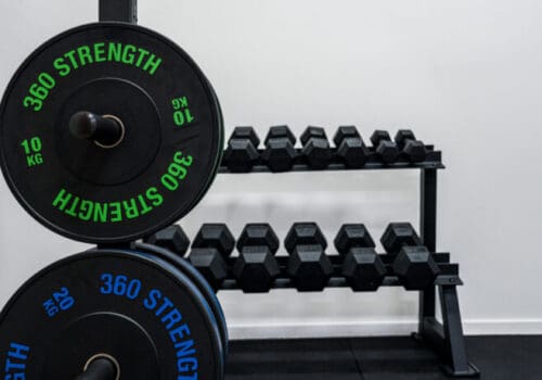 Weight plates and dumbbells in gym rehab space