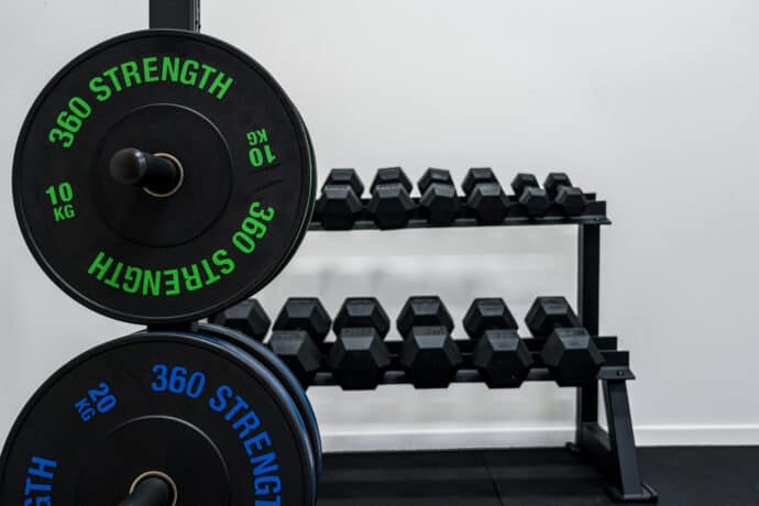 Weight plates and dumbbells in gym rehab space
