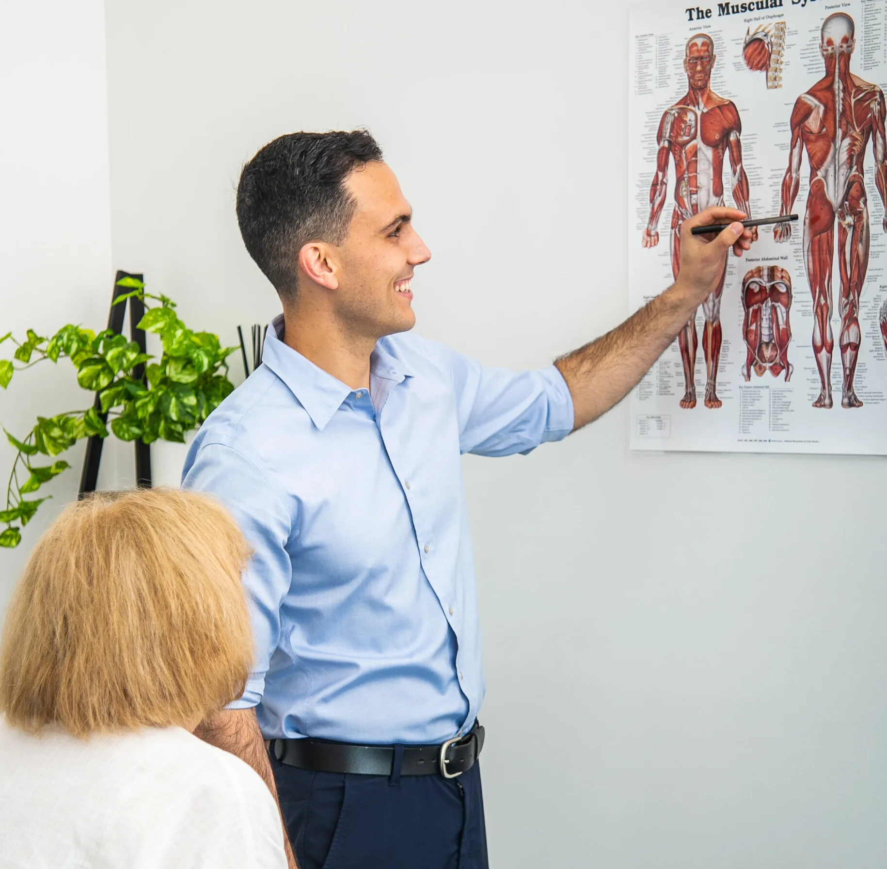 Male Geelong chiropractor educating and discussing with female client
