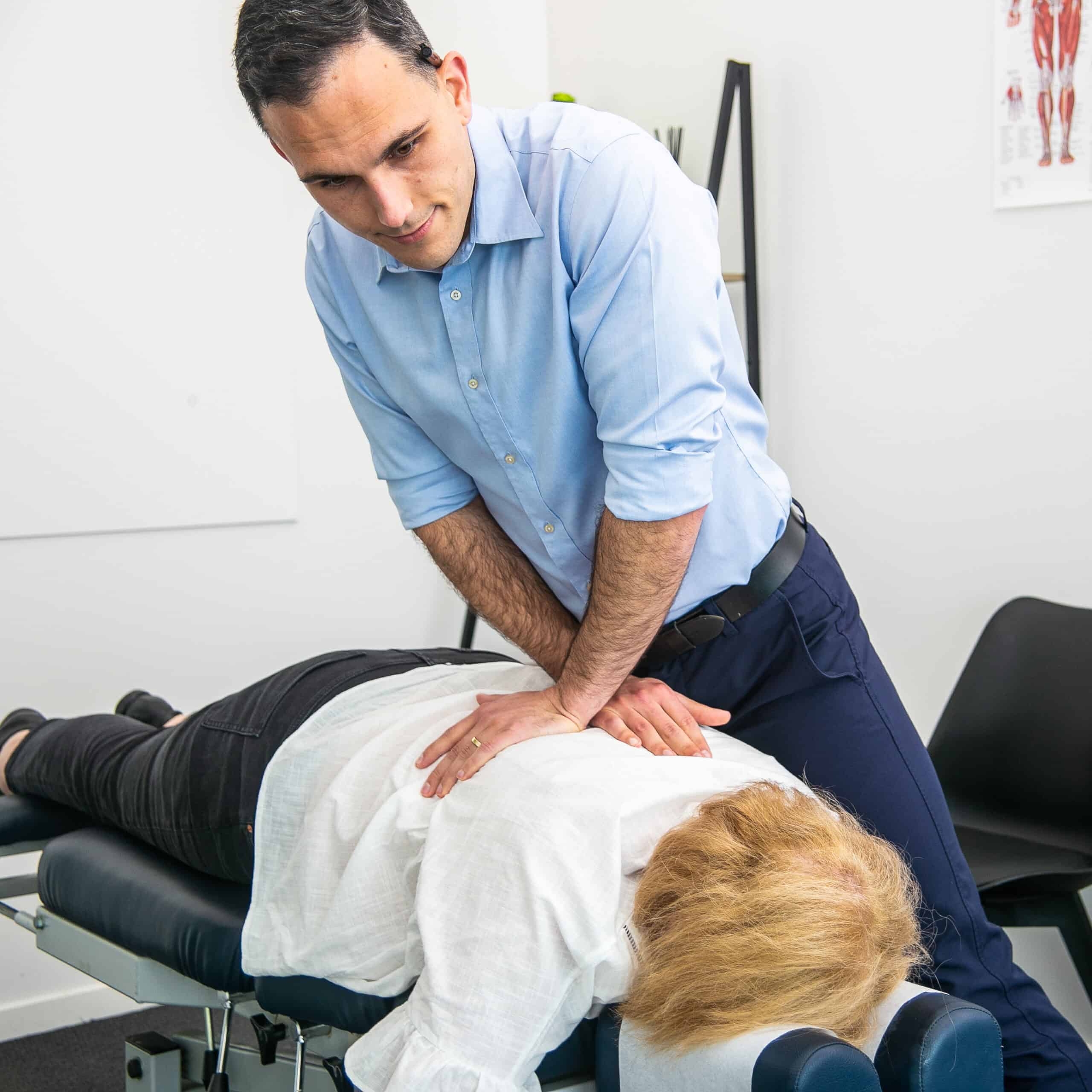 Geelong chiropractor performing manual adjustment to thoracic spine for back pain relief
