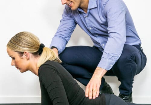 Geelong chiropractor performing rehabilitation and exercise therapy with female client