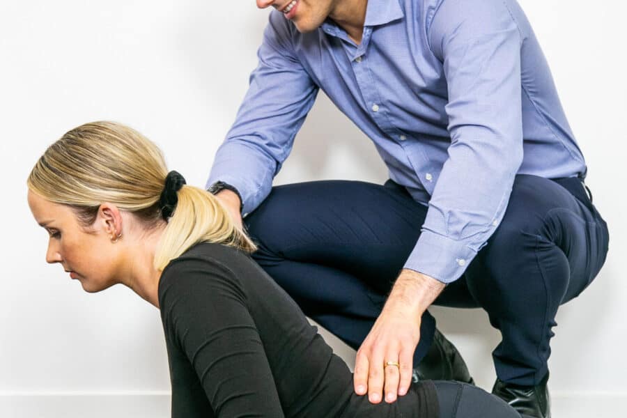 Geelong chiropractor performing rehabilitation and exercise therapy with female client