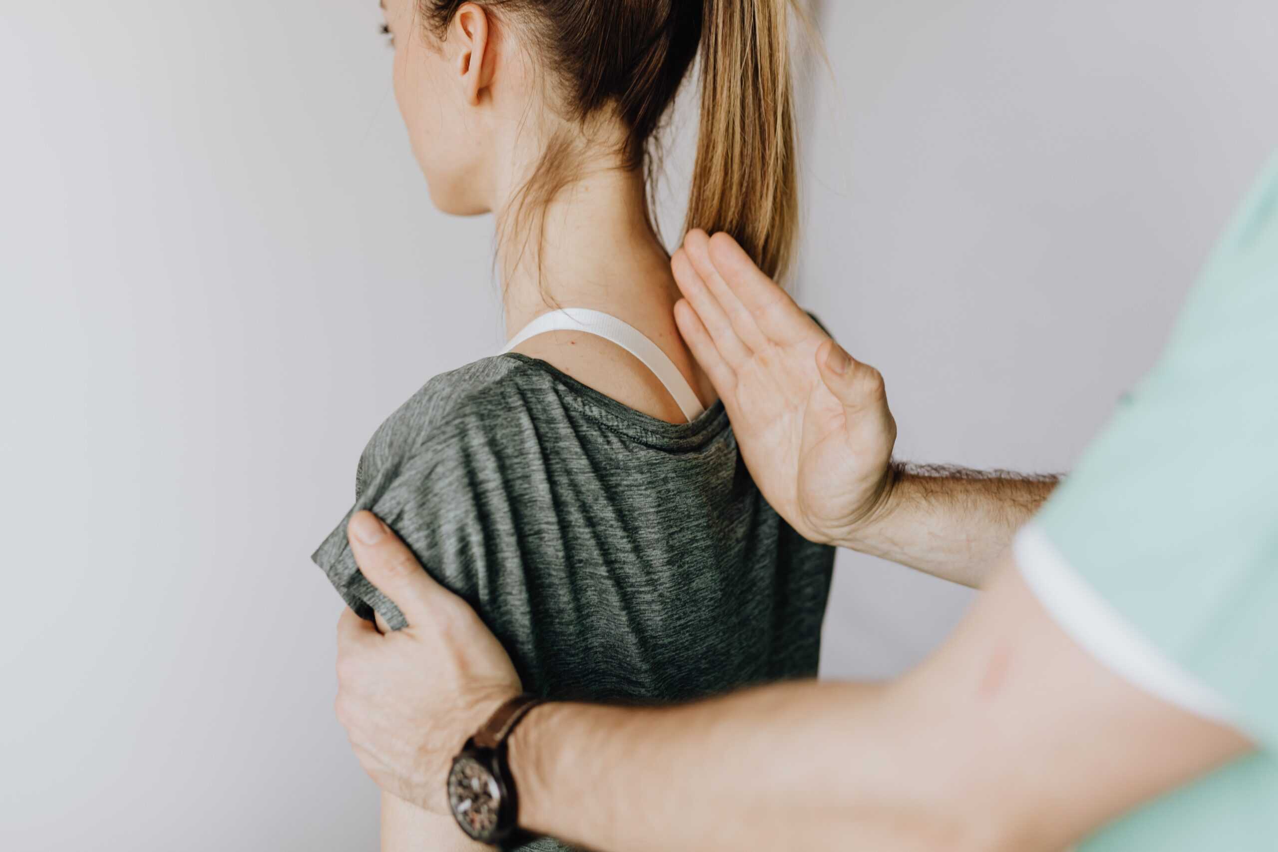 Geelong chiropractor assessing posture of female client