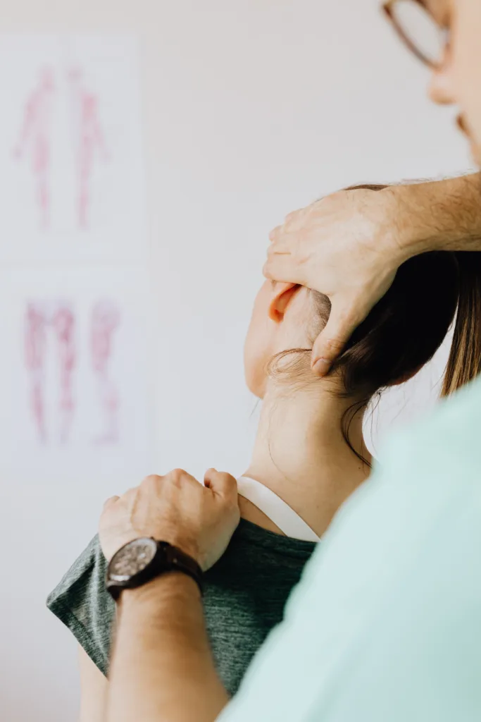 Geelong chiropractor hands on assessment of the neck and shoulder of female client
