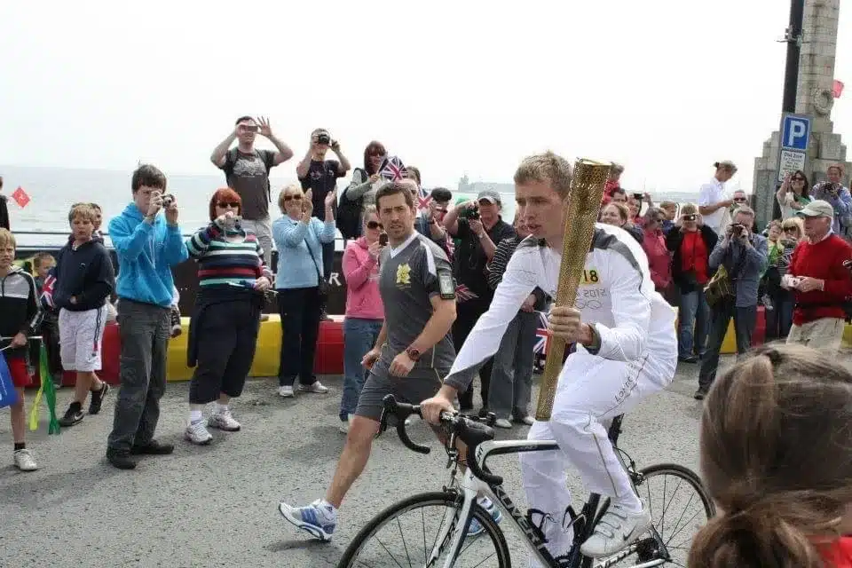 Geelong myotherapist Tom Black carrying olympic torch for London games